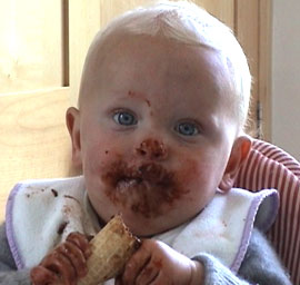 Baby eating with a messy face