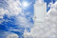 Door hanging in clouds in the sky