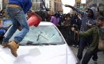 Rioters Smashing Car